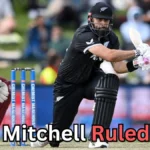 A cricket match scene showing a New Zealand batter playing a shot while a West Indies wicketkeeper crouches behind the stumps. The ball is in motion near the batter’s bat. Text on the image reads: ‘Daryl Mitchell Ruled Out?