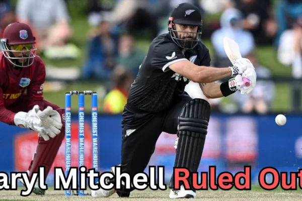 A cricket match scene showing a New Zealand batter playing a shot while a West Indies wicketkeeper crouches behind the stumps. The ball is in motion near the batter’s bat. Text on the image reads: ‘Daryl Mitchell Ruled Out?