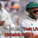 Side-by-side image of two cricket players in Test match uniforms. The player on the left, wearing a white kit and a dark blue helmet, is in a batting stance with his bat raised. The player on the right, also in a white kit, wears a green cap and pink sunglasses and is holding a red cricket ball. Text over the image reads: ‘IND vs SA 2nd Test LIVE: Rishabh Pant?