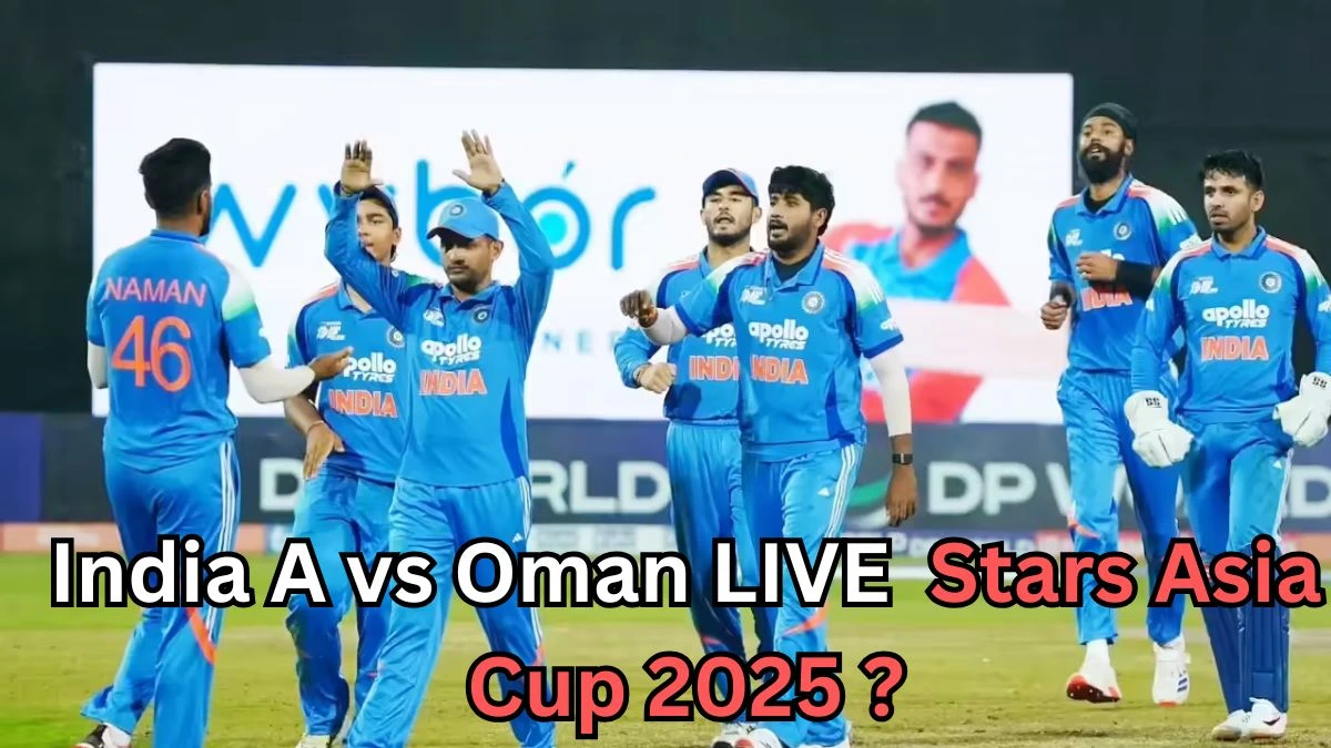 A group of India A cricket players wearing blue jerseys gather on the field during a match. One player has “NAMAN 46” on his back. The players appear to be celebrating or discussing a play. A large blurred screen with another player’s image is visible in the background. Text over the image reads: “India A vs Oman LIVE Stars Asia Cup 2025?
