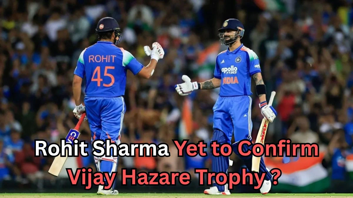Two Indian cricket players wearing blue jerseys on the field, giving each other a fist bump during a match. The player on the left has 'Rohit 45' on his jersey. The text on the image reads ‘Rohit Sharma Yet to Confirm Vijay Hazare Trophy?