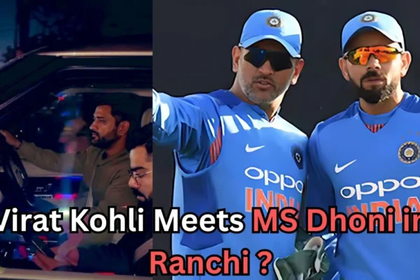 A split image. On the left, a man with a beard is driving a car at night while another man sits beside him using a phone. On the right, two men in blue cricket uniforms and caps stand together, one pointing ahead while both wear sunglasses. Text over the image reads: “Virat Kohli Meets MS Dhoni in Ranchi?”.