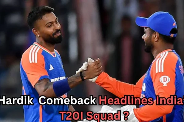 Two Indian cricket players in blue-and-orange jerseys are seen smiling and shaking hands on the field. One player is wearing a cap, and both appear to be celebrating a moment during a match. Text across the bottom of the image reads: “Hardik Comeback Headlines India’s T20I Squad?