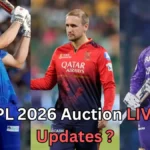 Promotional graphic for IPL 2026 Auction Live Updates showing three professional male cricketers in team jerseys. On the left, a batter in a blue kit plays an aggressive shot with the bat raised. In the center, a player in a red-and-black jersey stands facing forward. On the right, a batter in a purple kit holds a bat while looking ahead. Text at the bottom reads “IPL 2026 Auction LIVE Updates?