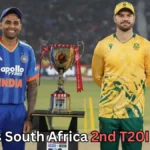 Captains of India and South Africa stand beside the T20I trophy on the cricket field before the match. The Indian captain wears a blue jersey, while the South African captain wears a yellow and green kit. Text on the image reads ‘India vs South Africa 2nd T20I 2025?’