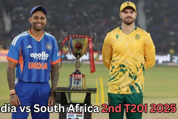 Captains of India and South Africa stand beside the T20I trophy on the cricket field before the match. The Indian captain wears a blue jersey, while the South African captain wears a yellow and green kit. Text on the image reads ‘India vs South Africa 2nd T20I 2025?’