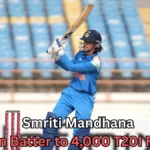 A female cricket player in India’s blue uniform swings her bat during a match, wearing a helmet and gloves, with empty blue stadium seats in the background and on-image text about reaching 4,000 T20I runs.