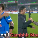 A man in a blue cricket uniform is seen greeting two different men on a cricket field in a split-frame image. On the left, he is hugging one man, and on the right, he is shaking hands with another man holding a microphone. The background shows a stadium with bright lights. Text at the bottom reads “Virat Kohli Gambhir Moment?