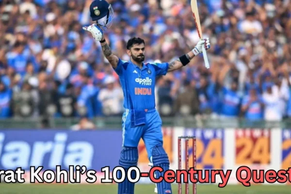 A cricketer in a blue uniform stands on the field holding his helmet in one hand and his bat raised in the other while facing a cheering crowd in the stadium. Stumps are visible behind him. Text at the bottom of the image reads “Virat Kohli’s 100-Century Quest?