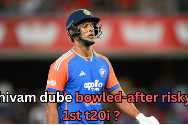 The image you've uploaded features cricketer Shivam Dube, likely following a moment of disappointment during the first T20I match. The text overlay reads, "Shivam Dube Bowled-after Risky 1st T20I?" which could refer to Dube being dismissed or making an impact in a challenging situation during the match.